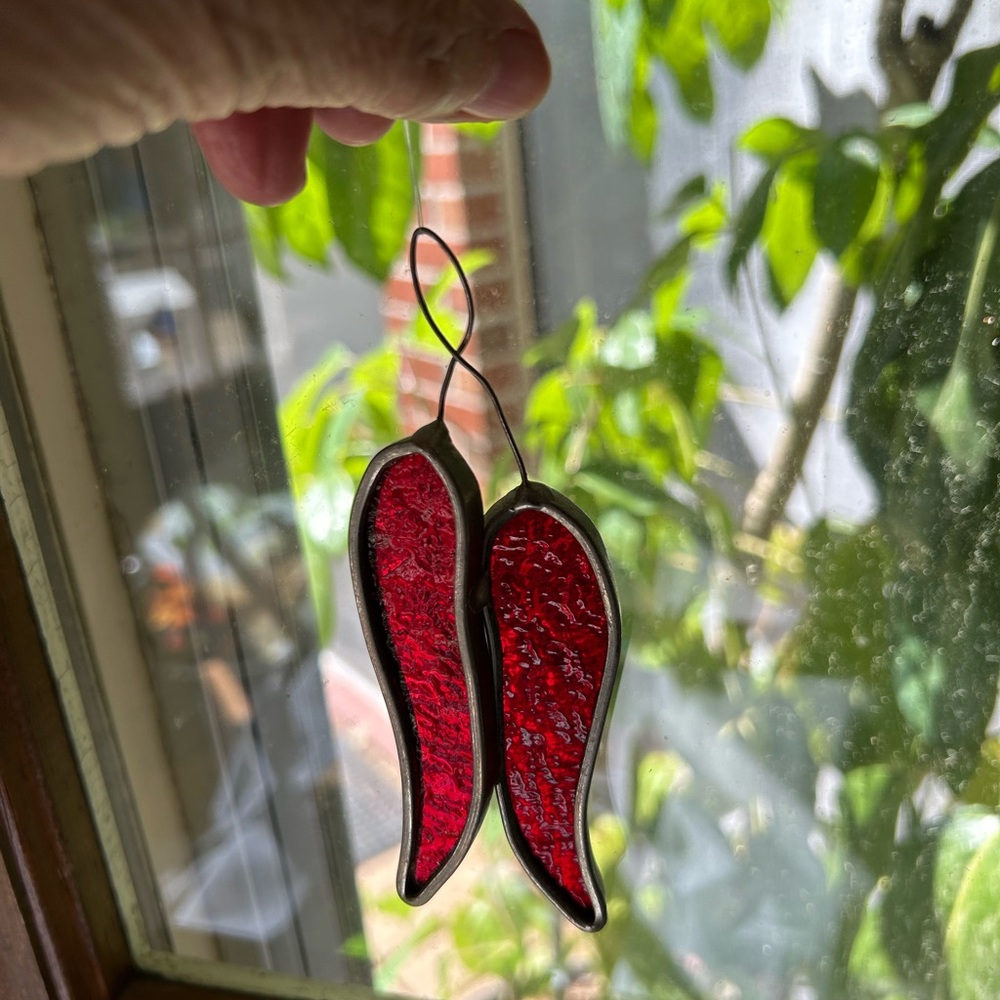 Hot Red Peppers stained glass suncatcher. 5” long. 2” wide.  Rippled red glass.